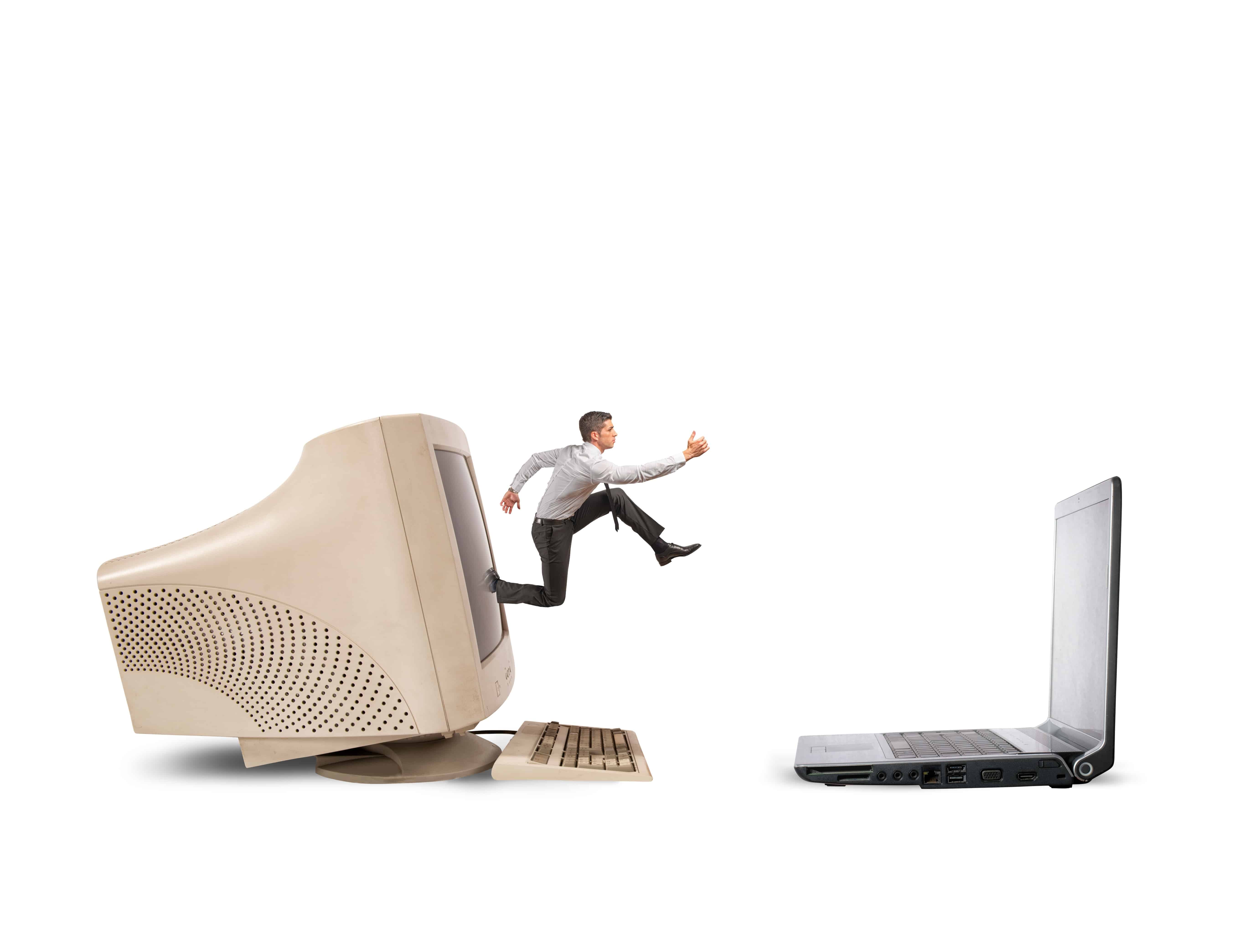 Man Jumping from Computer Monitor to Laptop, Representing Application Modernization | Software AG Government Solutions
