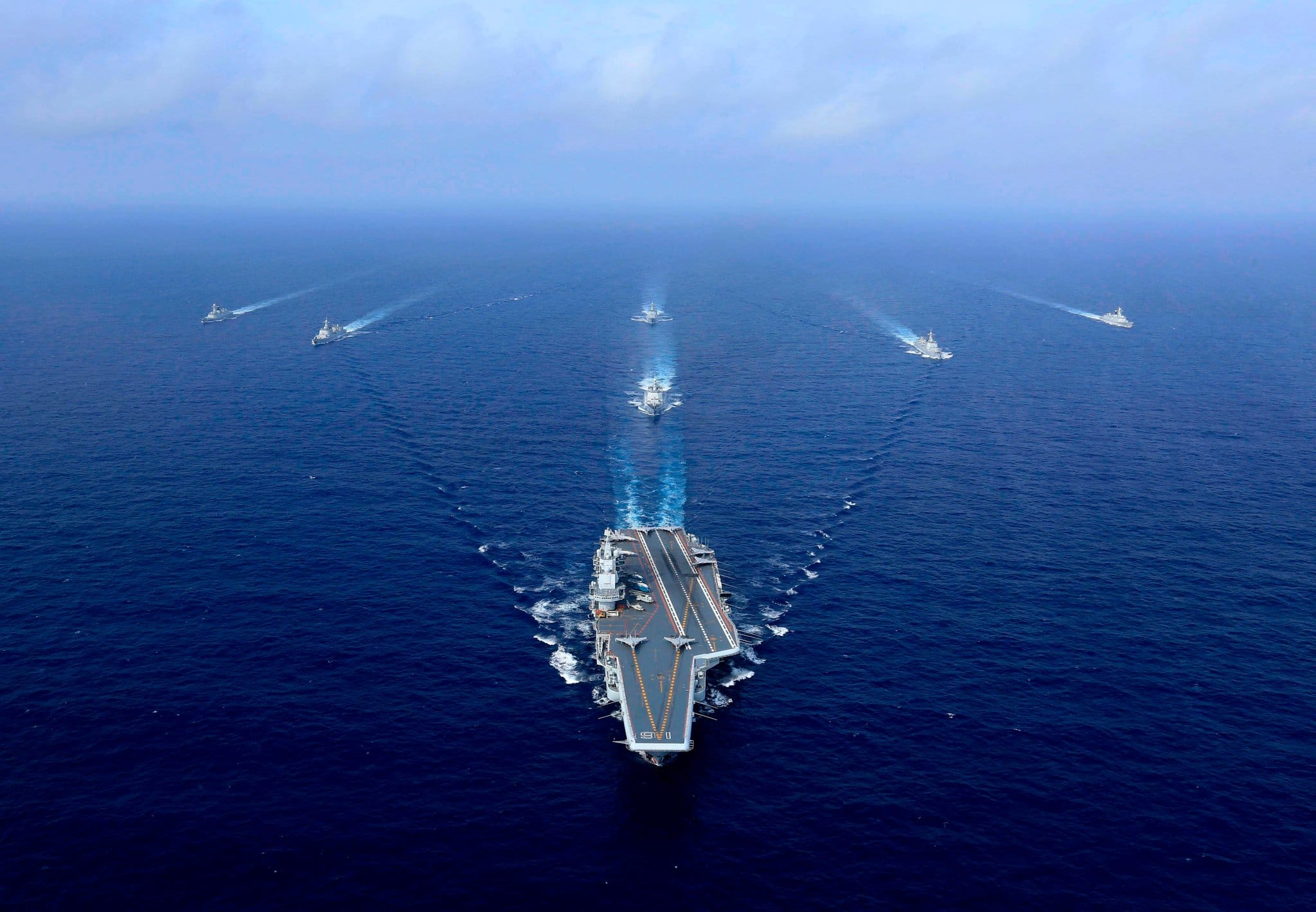 Seven US Navy ships sailing through the open ocean